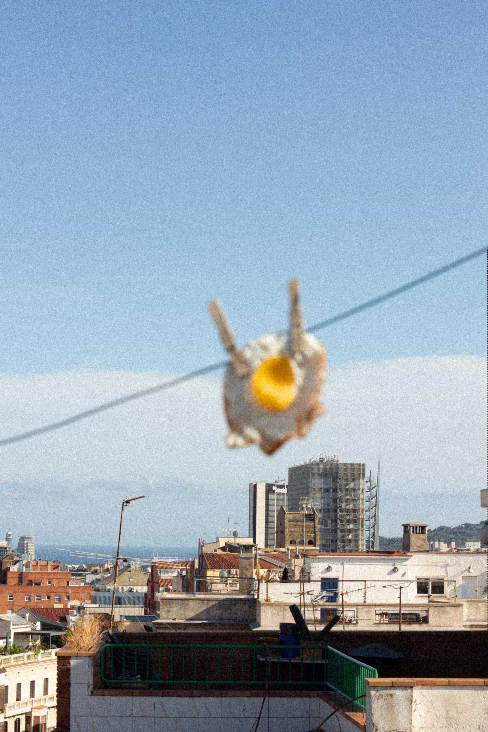 fried egg hanging with barcelona as background